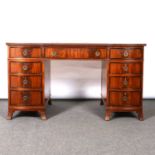 A reproduction mahogany twin pedestal desk,