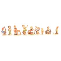 Nine Goebel Hummel figurines.
