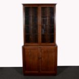 Edwardian oak bookcase in the Georgian style, moulded cornice, the upper section with glazed doors