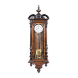 Walnut and ebonised Vienna wall clock, with a turned and carved finial, arched glazed door, with