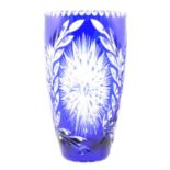 A large blue overlaid glass vase