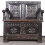 A carved oak monk’s bench,