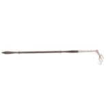 An antique hinged steel toasting fork with turned wooden handle.
