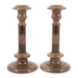 Pair of red serpentine marble candlesticks