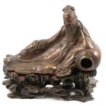 A Chinese bronze figure of dignitary, reclining