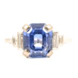A sapphire ring with two baguette cut diamonds in each shoulder.