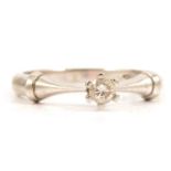 A diamond solitaire ring.