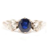 A sapphire and diamond three stone ring.