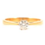 A diamond solitaire ring.