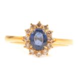 A sapphire and diamond cluster ring.