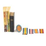 Box of containing books, military cap badges and medal ribbons.