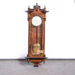 Vienna wall clock, walnut case, turned finials, glazed door, circular enamelled dial, twin weight-