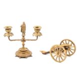 Brass candlestick; and a modern table cannon, (2).