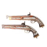 Two percussion pistols, with Eastern mother-of pearl decoration and brass mounts.