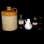A collection of glass and pottery apothecary jars and pots