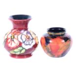 Moorcroft Pottery - a small Pomegranate pattern vase, and a modern Pansy pattern vase.