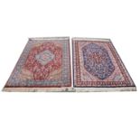 Two similar Persian pattern silk rugs