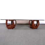 Pair of Chinese hardwood barrel seats and plate glass top forming a coffee table,