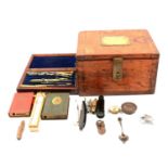 A oak box with two Post Office money boxes, compass, drawing set etc.