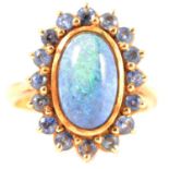 A black opal and sapphire dress ring