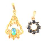 A modernist opal pendant, and an opal and sapphire 9ct yellow gold floral pendant.