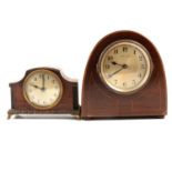 Three wooden and one plastic mantel clock.