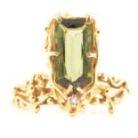 A handmade design 18 carat gold ring set with green tourmaline.