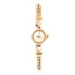 Omega - a lady's 9 carat yellow gold bracelet watch.