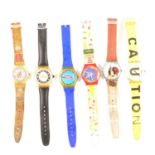 Swatch - Nineteen novelty watches, a Brooks & Bentley charm bracelet, and a London charm bracelet.