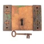 Antique iron door lock with original key, on wooden block