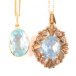 A heat treated blue topaz pendant and a spinel pendant.