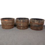 Seven half barrel garden planters.