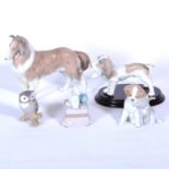 Four Lladro dog figures, and another of an Owl