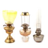 Cut glass oil lamp, a brass oil lamp, and another