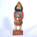 Carved and painted figure on base.