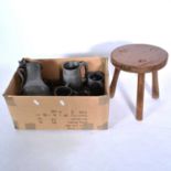 A collection of pewterware and a rustic three legged stool.