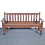 Stained teak garden bench, and two matching chairs.