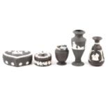 Wedgwood black jasperware lidded trinket boxes, vases, pin dishes, lighters and dwarf candlesticks.