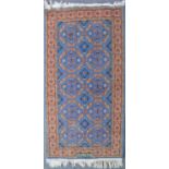 Pair of Persian pattern blue ground rugs, and two other rugs