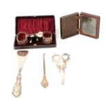 A cased set of silver salts, bakelite book photograph frame, grape scissors, button hook and shoe ho