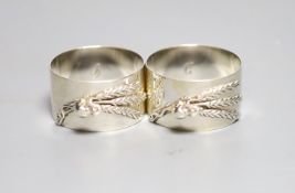 A modern pair of silver napkin rings cast with mice and wheatsheaf, by Sarah Jones, London, 1986,