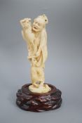 A Japanese ivory okimono of a man with giant rats clambering over him, signed, late 19th century