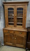 An Edwardian pine dresser, with two glazed doors over two drawers and panelled doors, width 107cm,