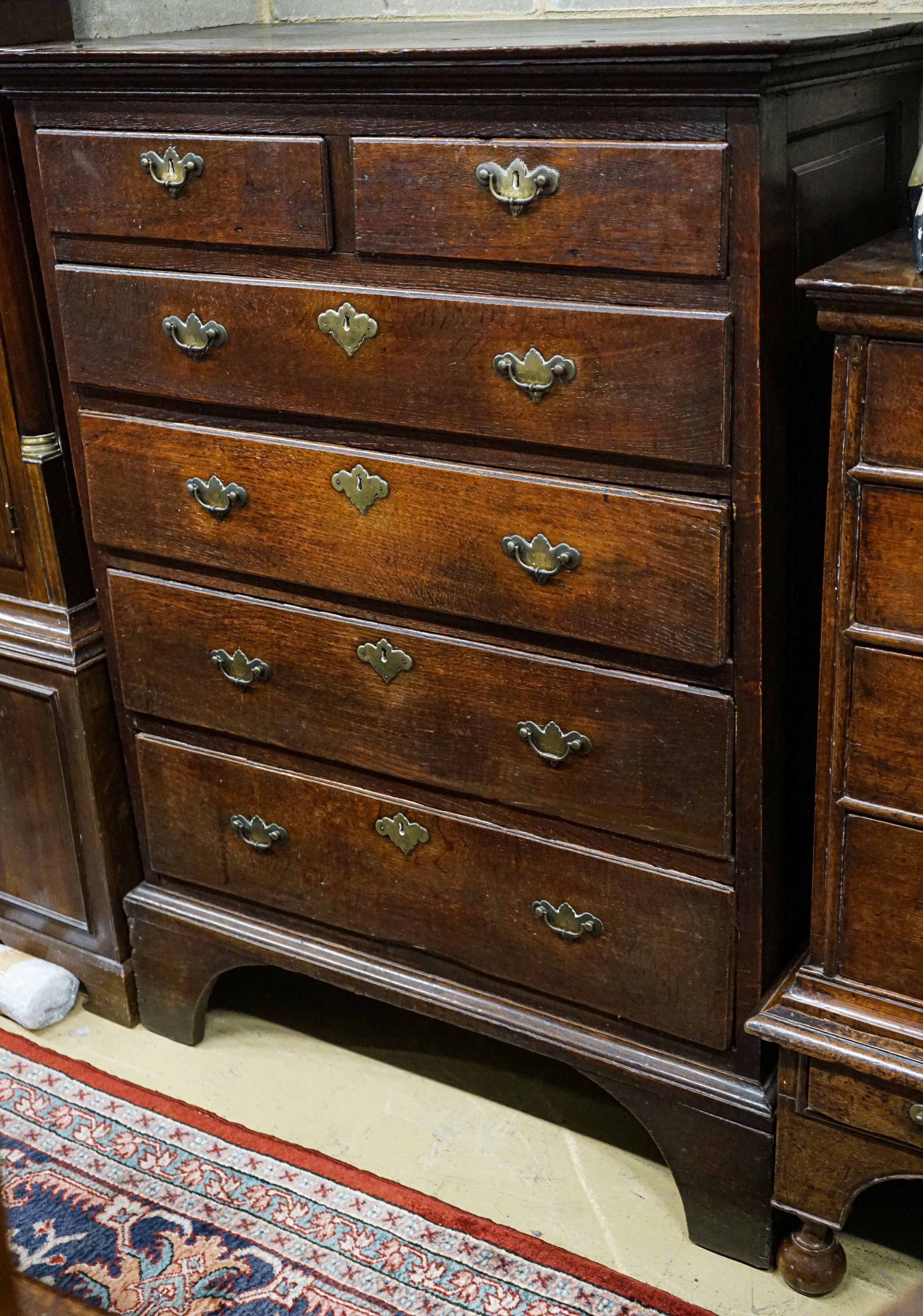 A George III oak chest of two short and four long drawers, on bracket feet, width 102cm, depth 56cm,