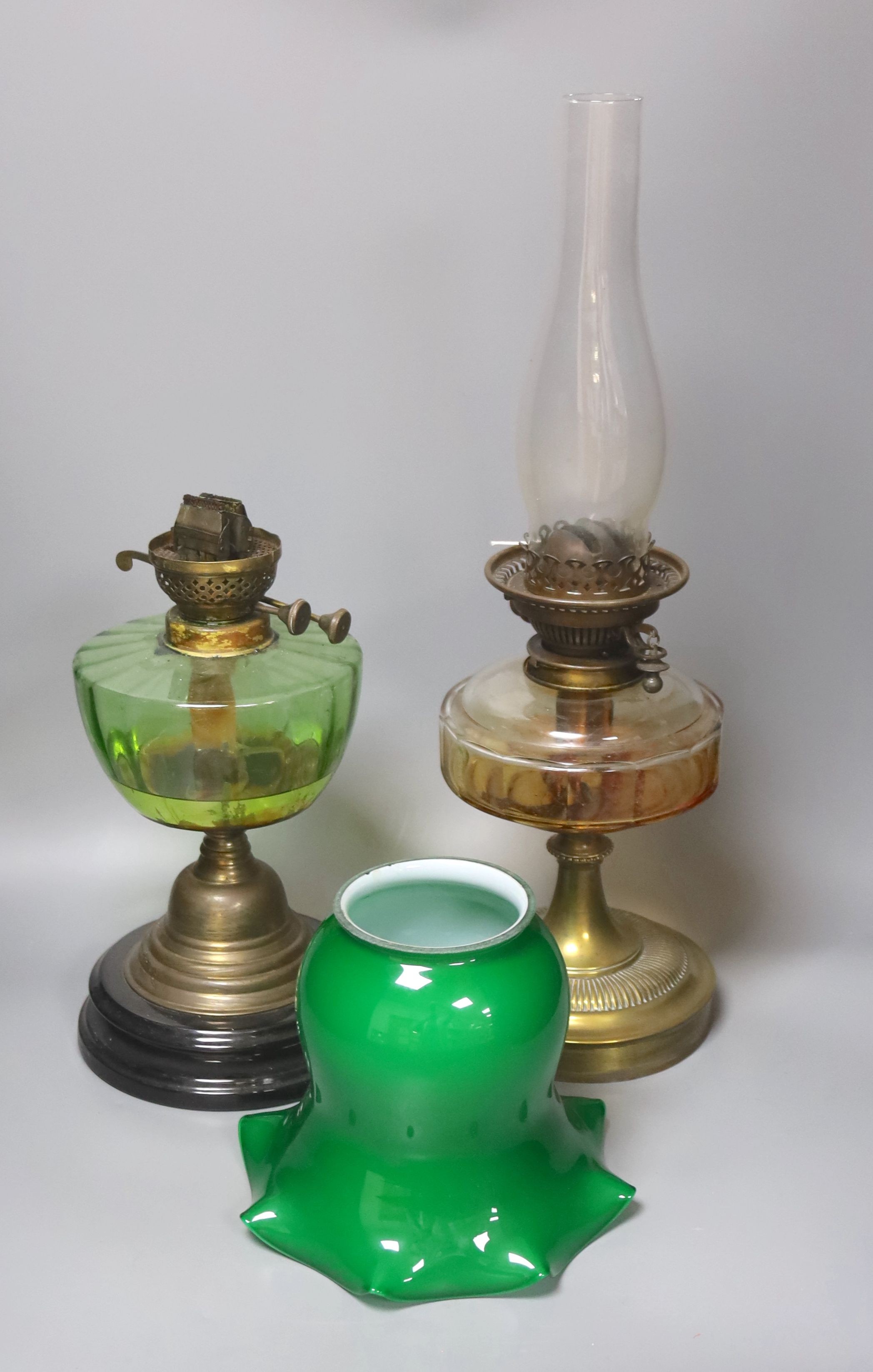 A brass green shade oil lamp and another oil lamp, 53cm