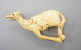 A Japanese ivory netsuke of a horse, late 18th/early 19th century, lacking rider and re-shaped at