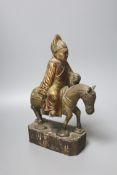 An 18th/19th century Chinese lacquered wood group of an official riding a horse, 30cm