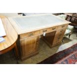 An Edwardian stripped beech pedestal desk, fitted eleven drawers, width 138cm, depth 80cm, height