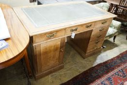 An Edwardian stripped beech pedestal desk, fitted eleven drawers, width 138cm, depth 80cm, height