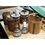 Six assorted treen measures and butter pails, a pair of pricket candlesticks, height 37cm and